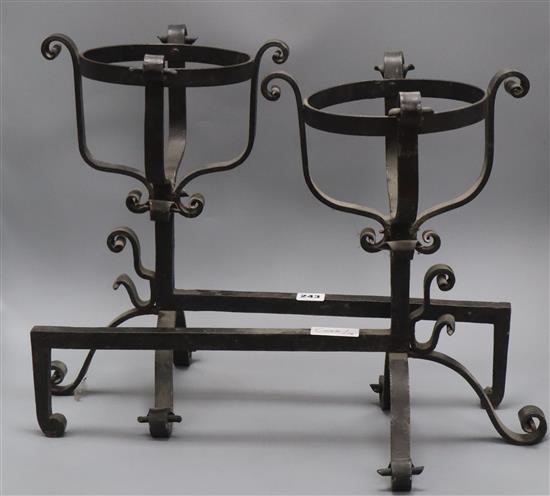 A pair of wrought iron fire dogs